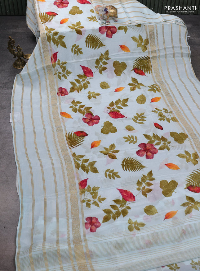 Semi georgette saree teal blue with allover floral prints and long zari woven border