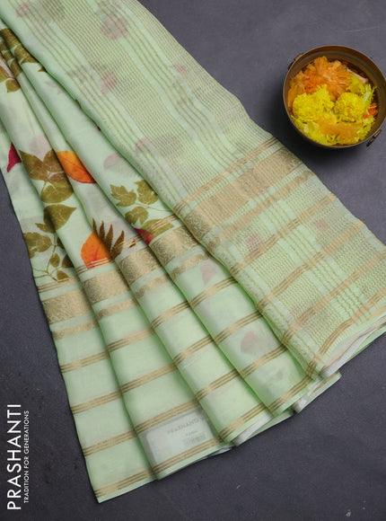 Semi georgette saree pista green with allover floral prints and long zari woven border