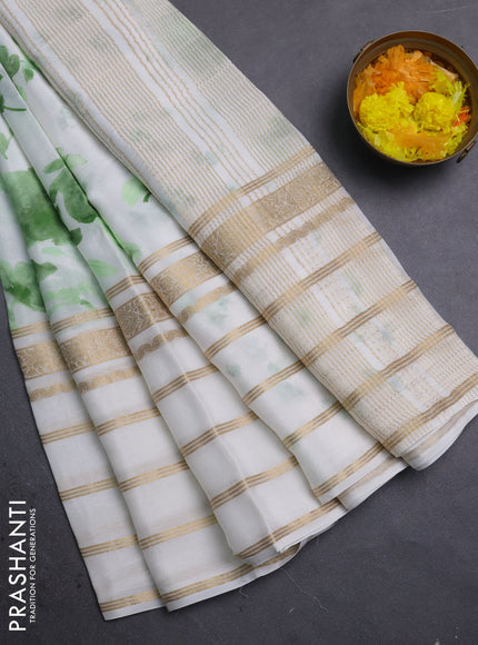Semi georgette saree off white and green with allover floral prints and long zari woven border
