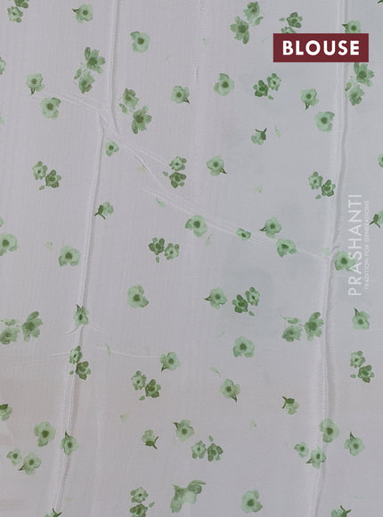 Semi georgette saree off white and green with allover floral prints and long zari woven border