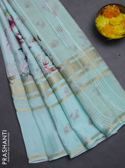 Semi georgette saree teal green shade with allover floral prints and long zari woven border