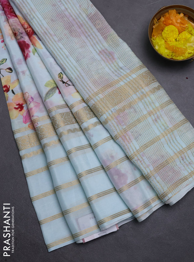 Semi georgette saree teal blue with allover floral prints and long zari woven border