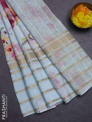 Semi georgette saree teal blue with allover floral prints and long zari woven border
