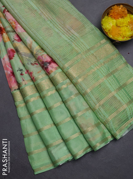 Semi georgette saree light green with allover floral prints and long zari woven border