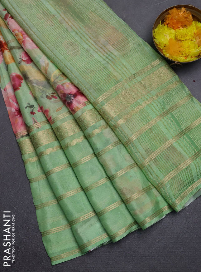 Semi georgette saree light green with allover floral prints and long zari woven border
