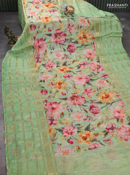 Semi georgette saree light green with allover floral prints and long zari woven border
