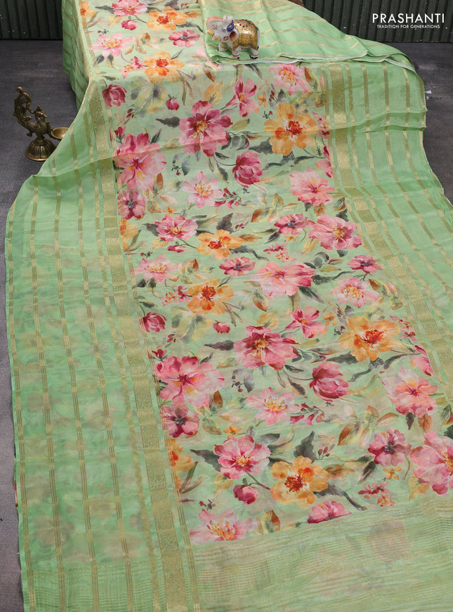 Semi georgette saree light green with allover floral prints and long zari woven border
