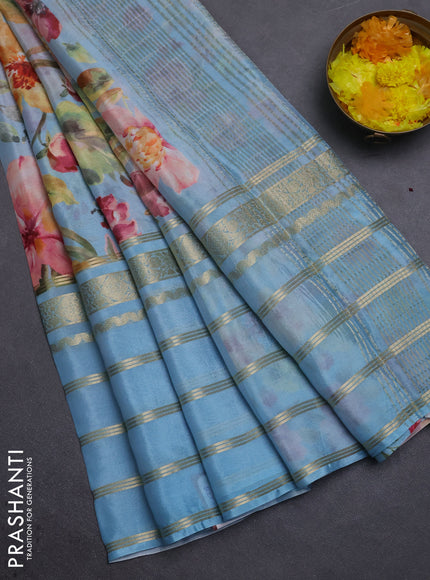 Semi georgette saree pastel blue with allover floral prints and long zari woven border