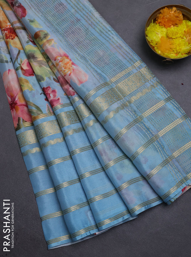 Semi georgette saree pastel blue with allover floral prints and long zari woven border