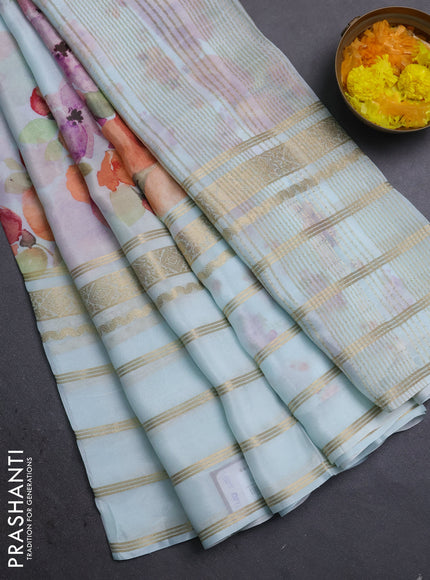 Semi georgette saree teal blue with allover floral prints and long zari woven border