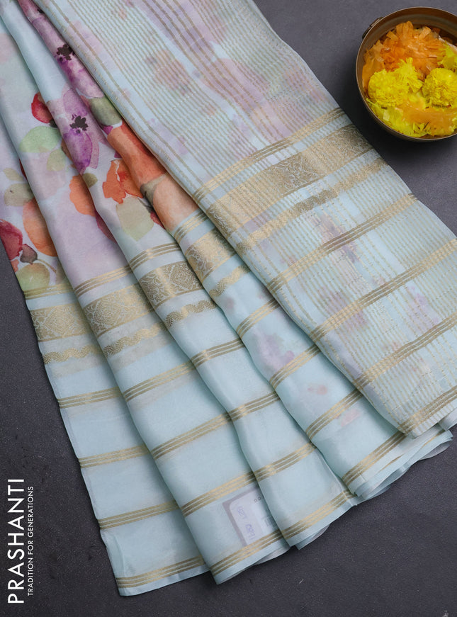 Semi georgette saree teal blue with allover floral prints and long zari woven border