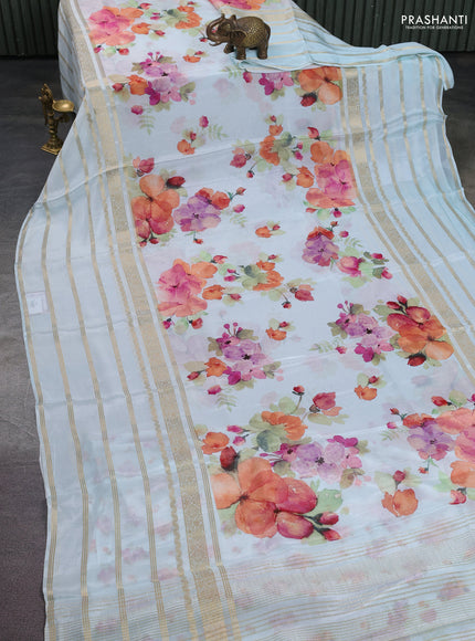 Semi georgette saree teal blue with allover floral prints and long zari woven border