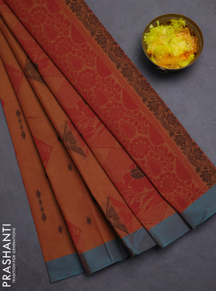 Nithyam cotton saree rust shade and teal green with thread woven geometric buttas and simple border