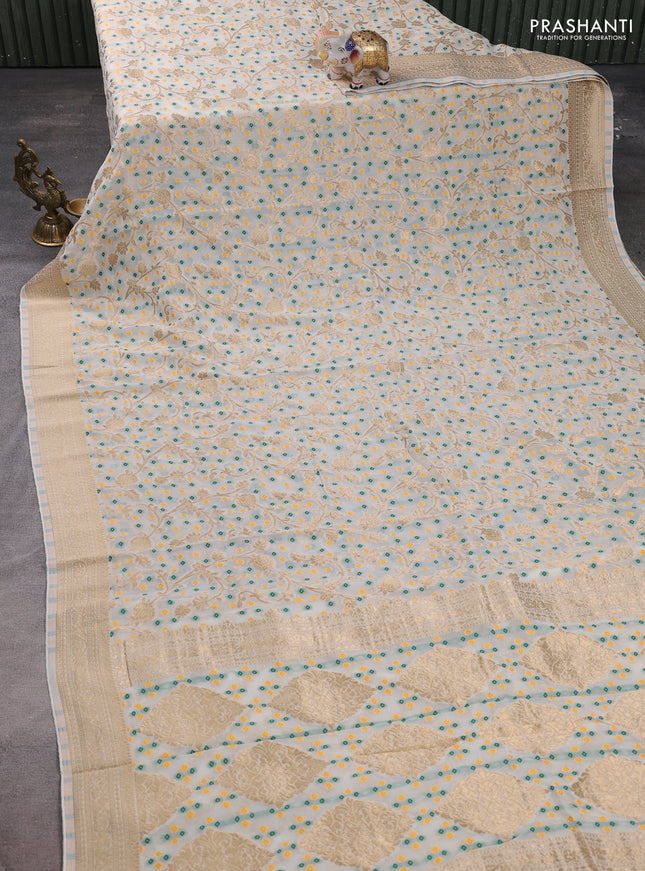 Banarasi semi georgette saree cream with allover zari weaves & bandhani thread buttas and zari woven border