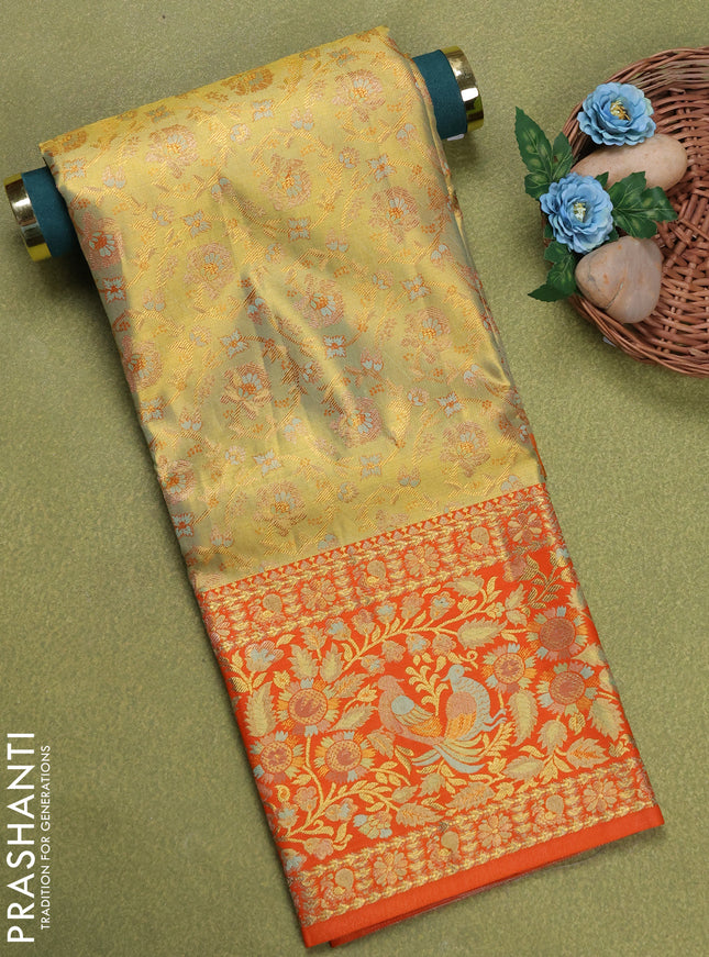 Pure silk tissue unstitched kids lehenga dual shade of pastel green and orange with allover silver zari woven brocade weaves and long rich zari woven border