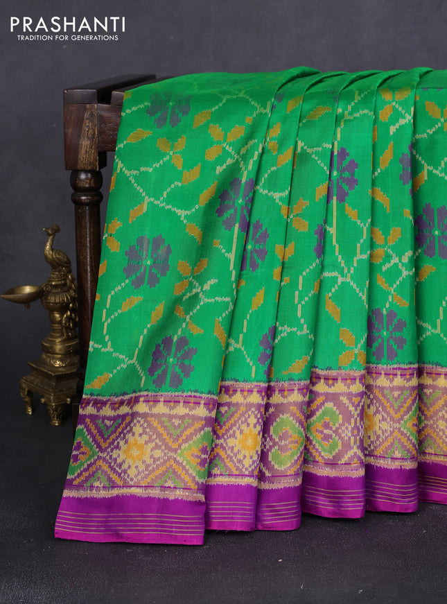 Rajkot patola silk saree green and purple with allover ikat weaves and ikat woven border