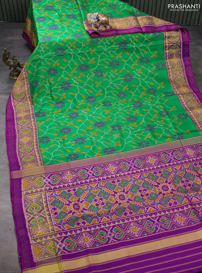 Rajkot patola silk saree green and purple with allover ikat weaves and ikat woven border