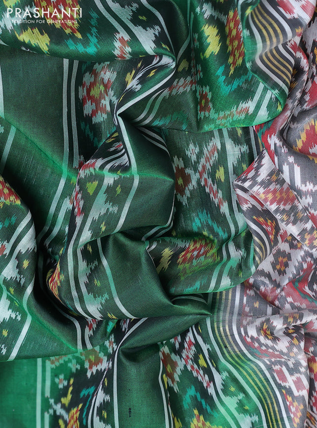 Rajkot patola silk saree off white  and green with allover ikat weaves and ikat woven zari border