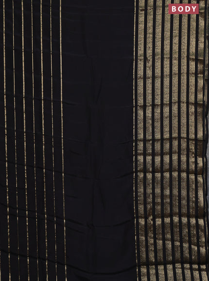 Semi mysore silk saree black and orange with plain body and long zari woven border