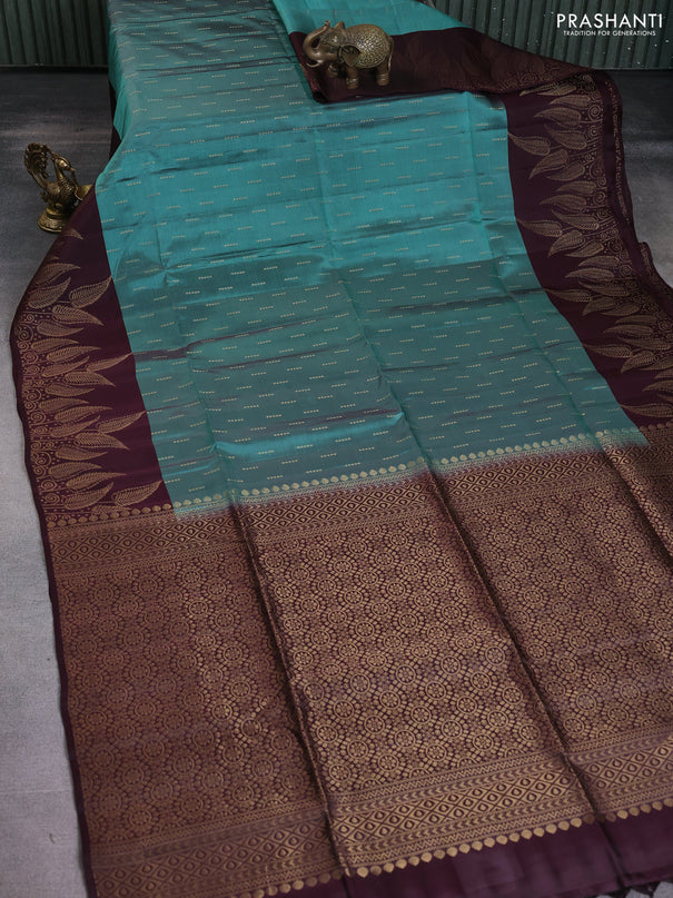 Kanchipuram soft silk saree teal green shade and wine shade with allover zari woven buttas and long zari woven leaf border