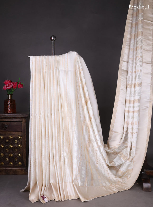 Semi kanchipuram partly saree off white with allover silver & zari weaves and rettapet zari woven border