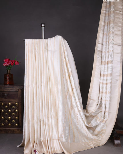 Semi kanchipuram partly saree off white with allover silver & zari weaves and rettapet zari woven border