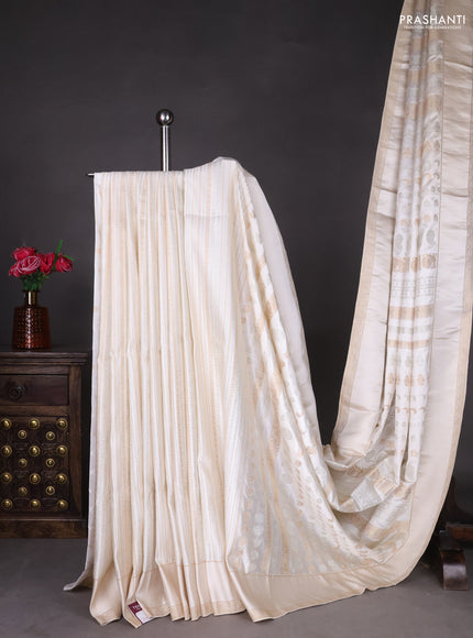 Semi kanchipuram partly saree off white with allover silver & zari weaves and rettapet zari woven border