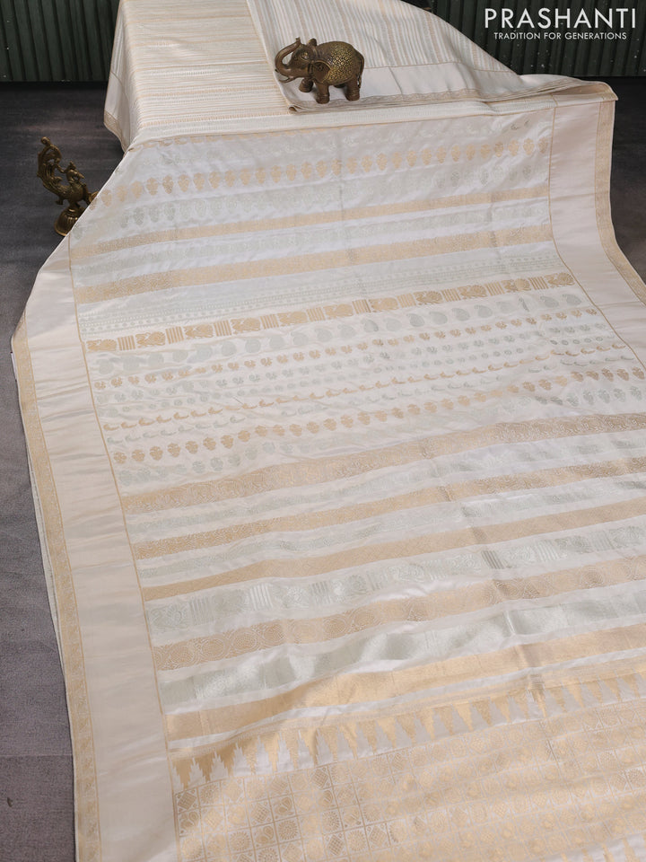 Semi kanchipuram partly saree off white with allover silver & zari weaves and rettapet zari woven border