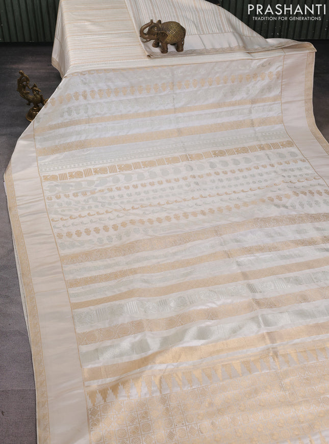 Semi kanchipuram partly saree off white with allover silver & zari weaves and rettapet zari woven border
