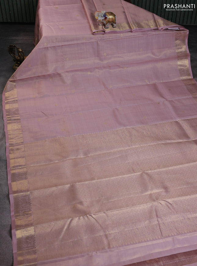 Pure kanchipuram silk saree pastel peach shade with allover zari weaves & buttas and rich zari woven border