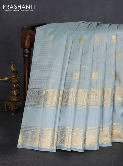 Pure kanchipuram silk saree pastel blue shade with allover zari woven checked pattern and long rettapet zari woven border