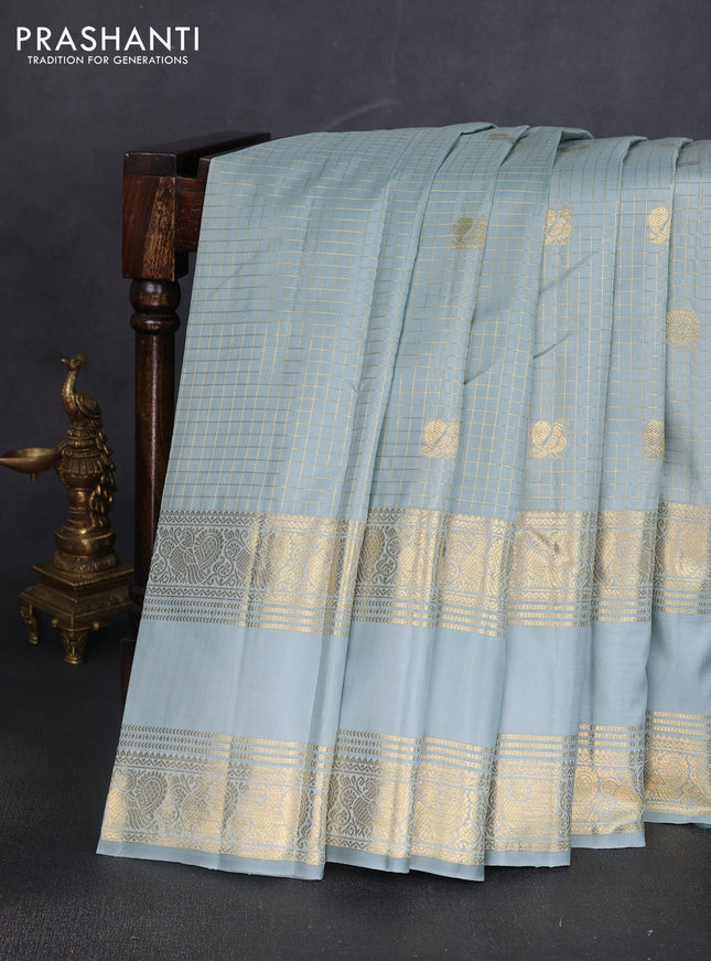Pure kanchipuram silk saree pastel blue shade with allover zari woven checked pattern and long rettapet zari woven border