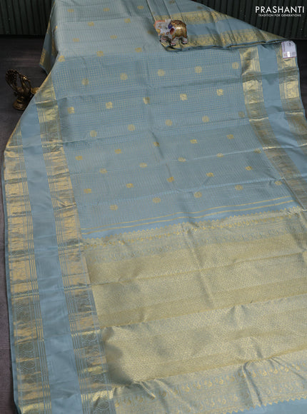 Pure kanchipuram silk saree pastel blue shade with allover zari woven checked pattern and long rettapet zari woven border