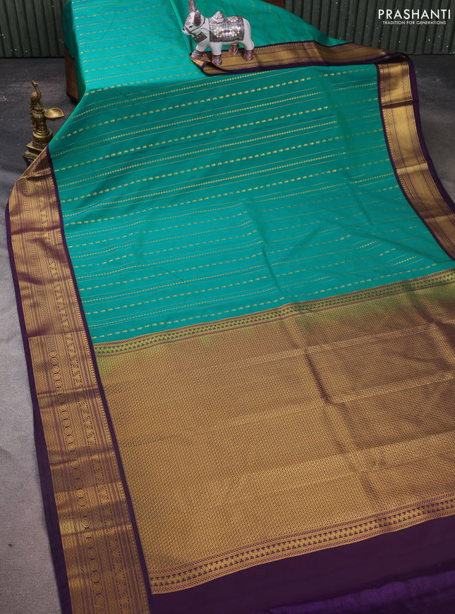 Semi kanchipuram silk saree green and purple with allover zari weaves & buttas and zari woven korvai border
