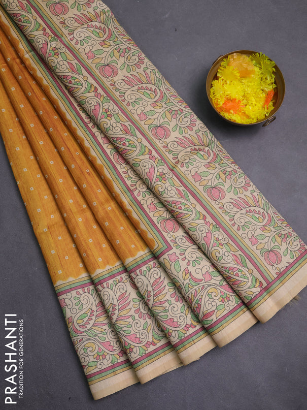 Semi tussar saree mustard yellow and cream with allover bandhani prints and madhubani printed pallu & border