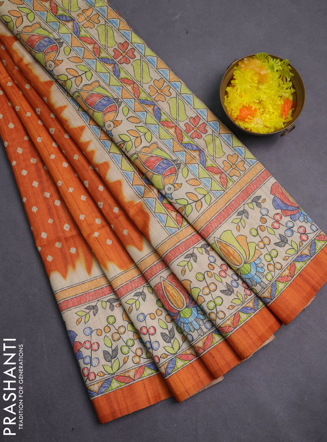 Semi tussar saree orange and beige with allover bandhani prints and madhubani printed pallu & border