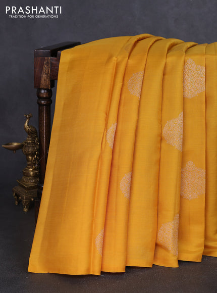 Kora kanchipuram silk saree mustard yellow and teal blue with zari woven buttas in bordeless style