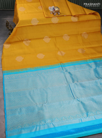 Kora kanchipuram silk saree mustard yellow and teal blue with zari woven buttas in bordeless style