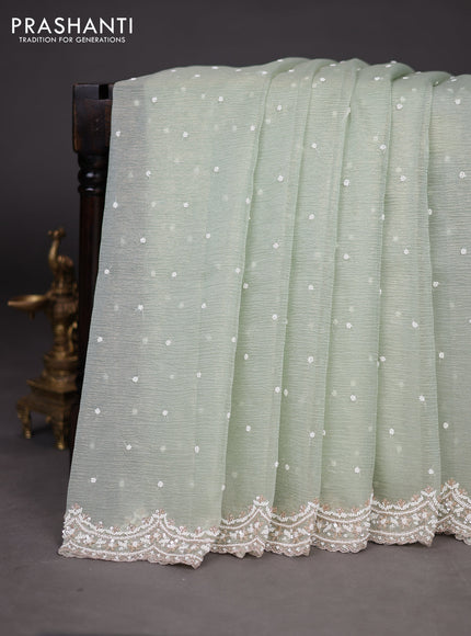 Crush tissue saree pastel green with sequin & cut beaded work