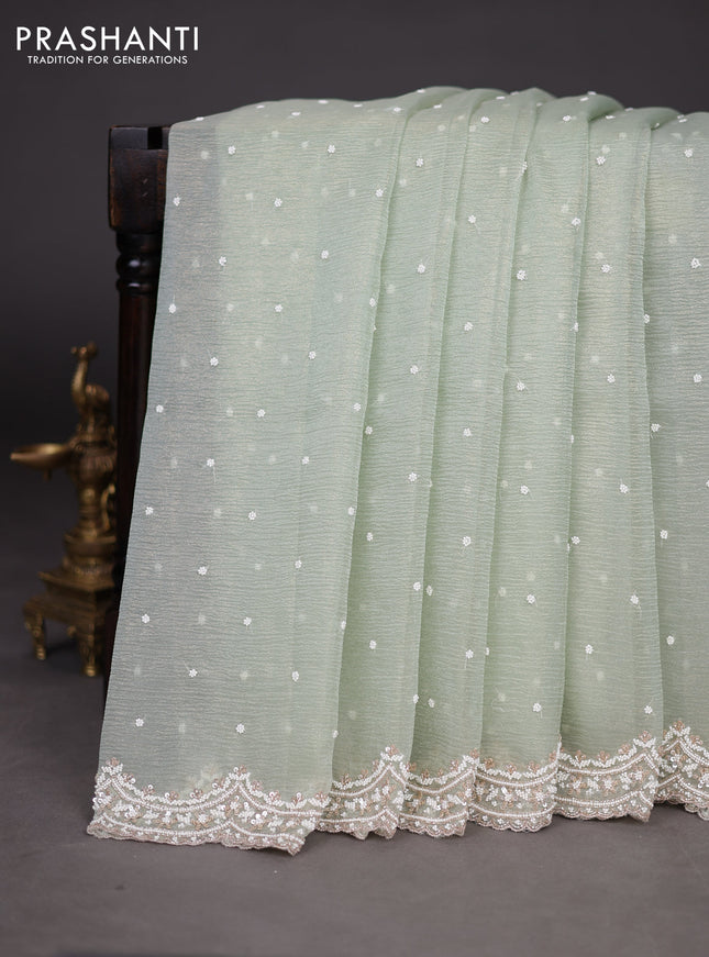 Crush tissue saree pastel green with sequin & cut beaded work