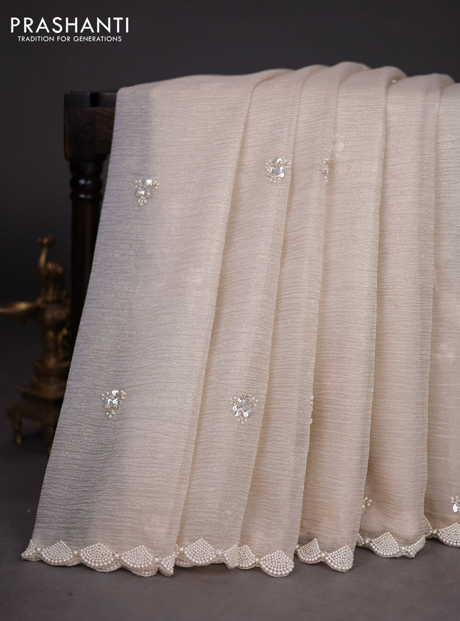 Crush tissue saree beige with sequin work buttas and beaded work border