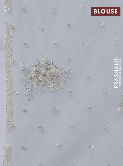 Organza silk saree off white with allover floral embroidery sequin work and beaded work border