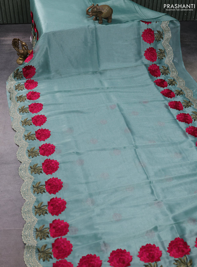 Tissue organza saree pastel green with plain body and floral embroidery border