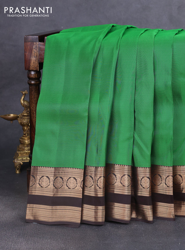 Kanchipuram silk saree green and coffee brown with allover zari woven butas and rettapet zari woven border