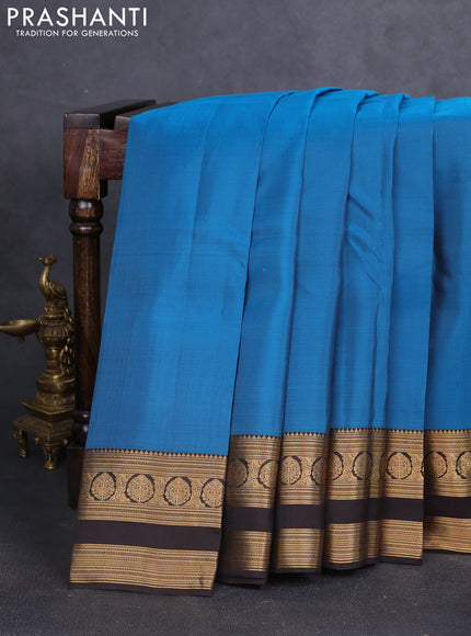 Kanchipuram silk saree peacock blue and coffee brown with plain body and rettapet zari woven border