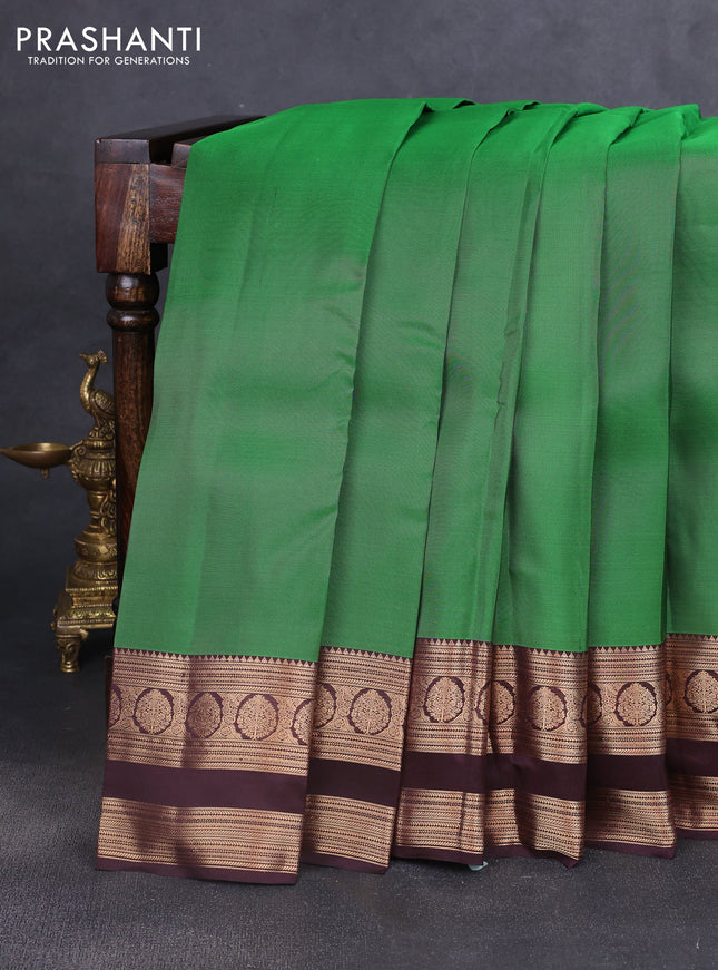 Kanchipuram silk saree green and coffee brown with plain body and rettapet zari woven border