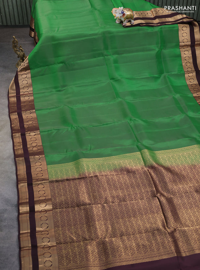 Kanchipuram silk saree green and coffee brown with plain body and rettapet zari woven border
