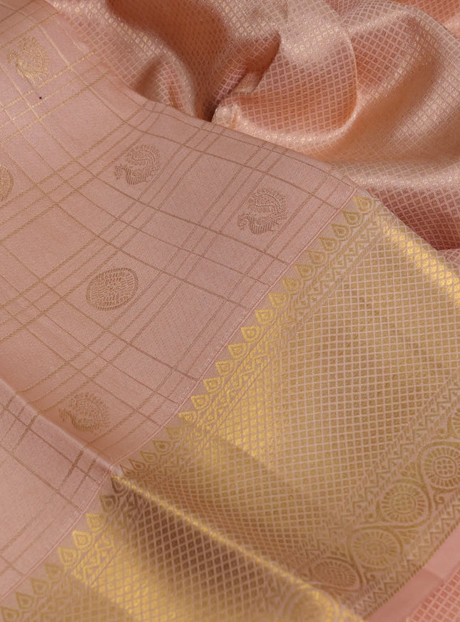 Pure kanchipuram silk saree pale orange with allover zari checks & buttas and rich zari woven border