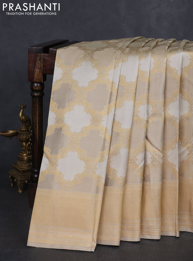 Pure kanchipuram silk saree beige with allover zari weaves and rich zari woven border