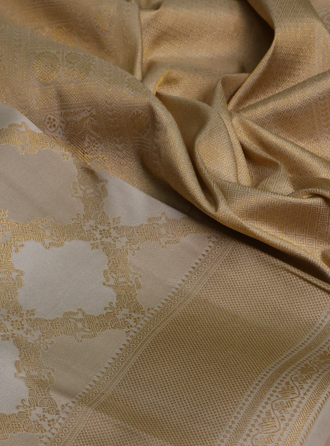 Pure kanchipuram silk saree beige with allover zari weaves and rich zari woven border